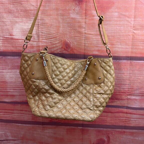 Gold quilted handbag on a wooden surface