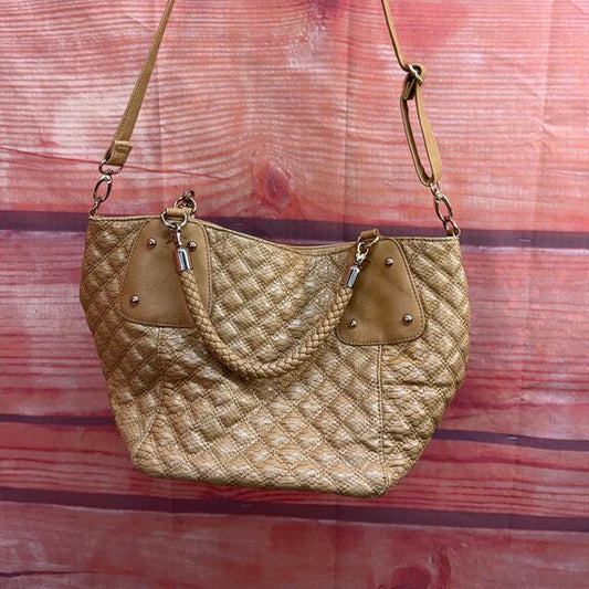 Gold quilted handbag on a wooden surface