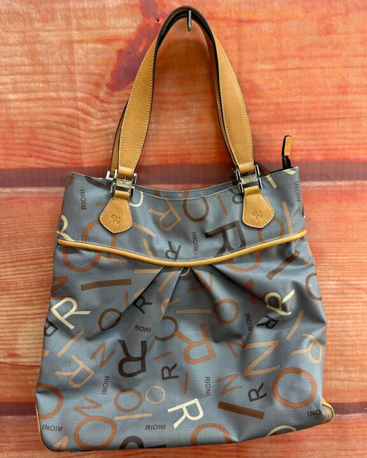 Gray handbag with brown and white lettering on a wooden surface